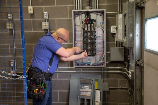 4-star electrician fixing electrical panel after blown fuse